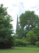 FirstU's spire, as seen from the Ottawa River bike path in Summer.