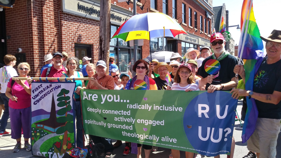 Members of the FirstU congregation, carrying FirstU banners and rainbow flags, at the Ottawa Pride Parade.